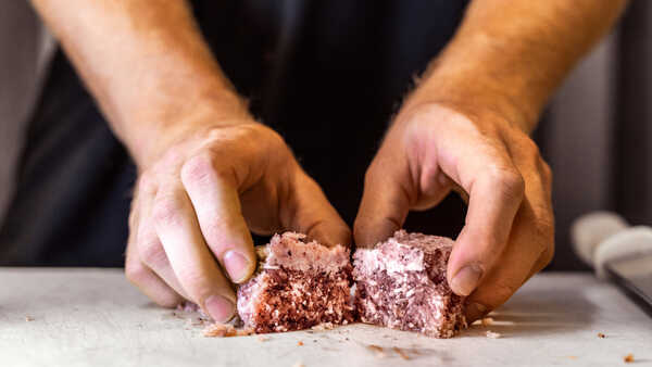 Biologist Walker Calhoun prepares a frozen krill steak. 