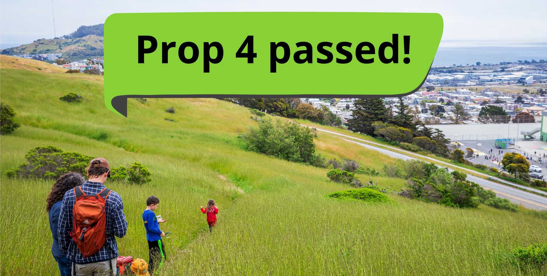 People hiking on a lush grassy hillside in San Francisco with a "Prop 4 passed!" banner at the top of the image