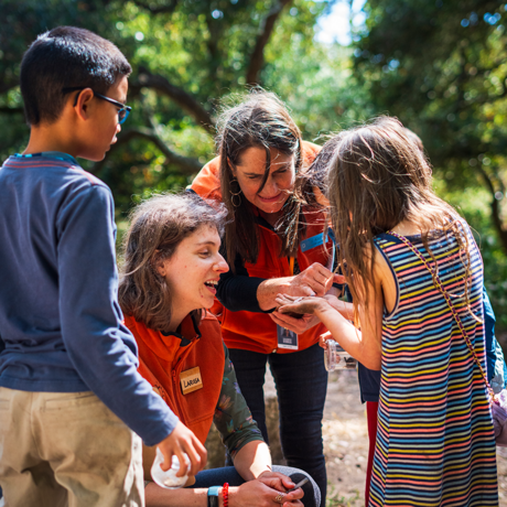 Children outside interacting with Academy staff members
